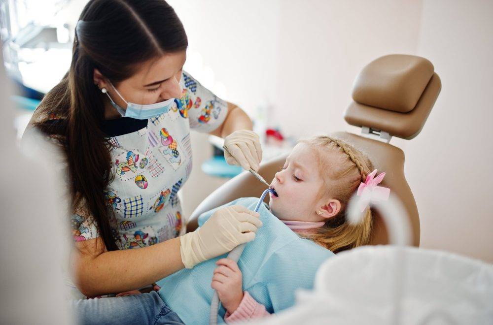 baby tooth Little baby girl at dentist chair. Children dental.